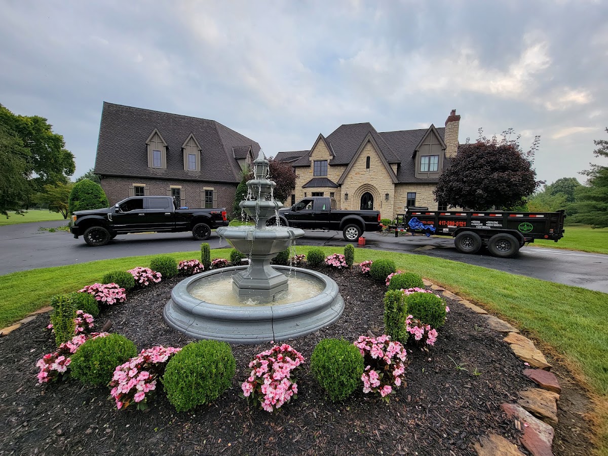 Turf Works trucks parked beside a finished fountain bed